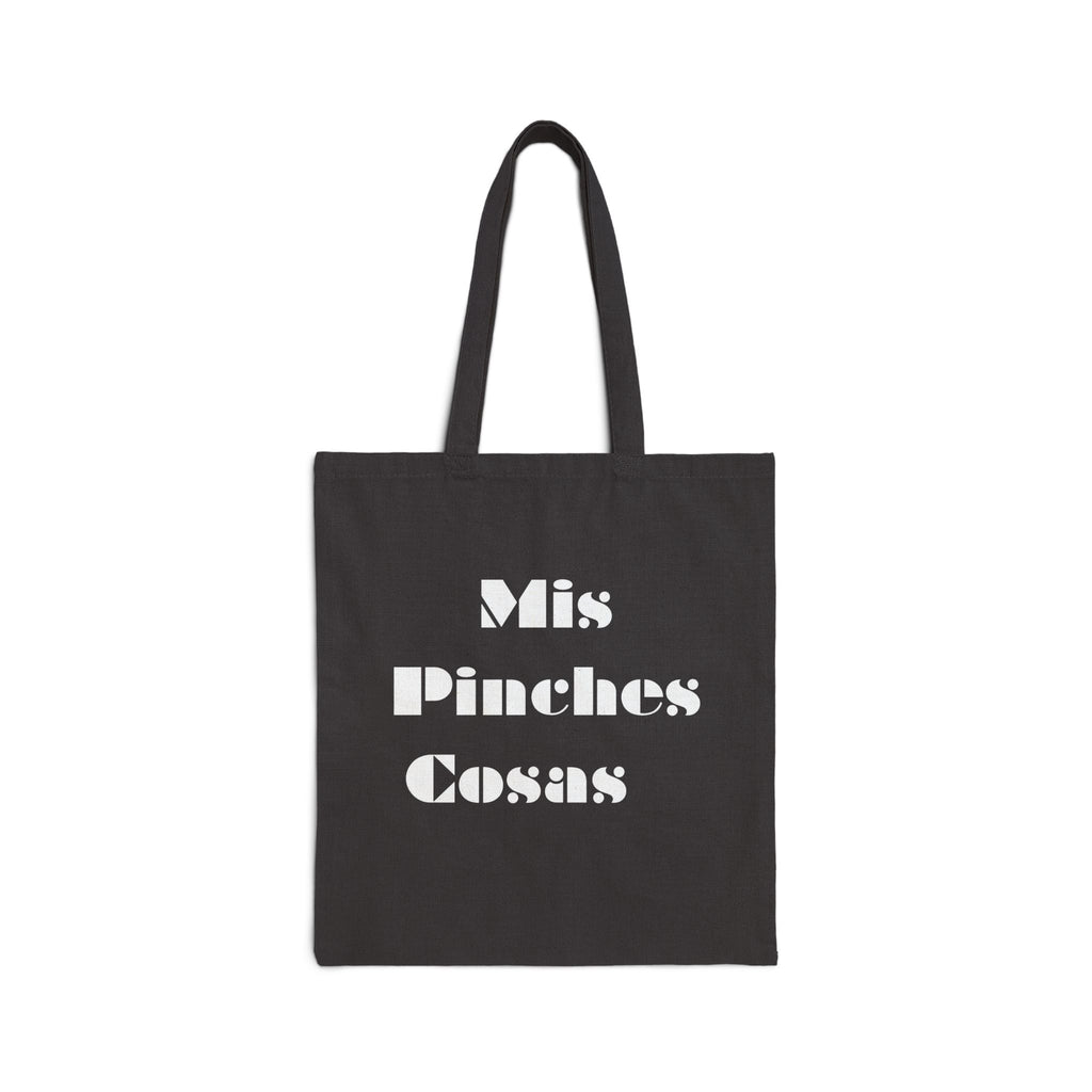 Black tote bag with white text 'Mis Pinches Cosas' on a white background