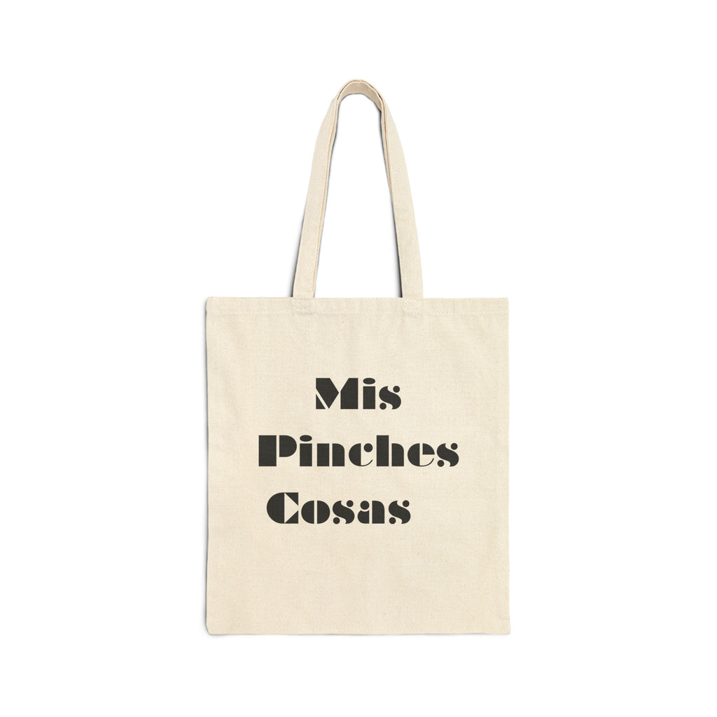 Beige tote bag with black text 'Mis Pinches Cosas' on a white background