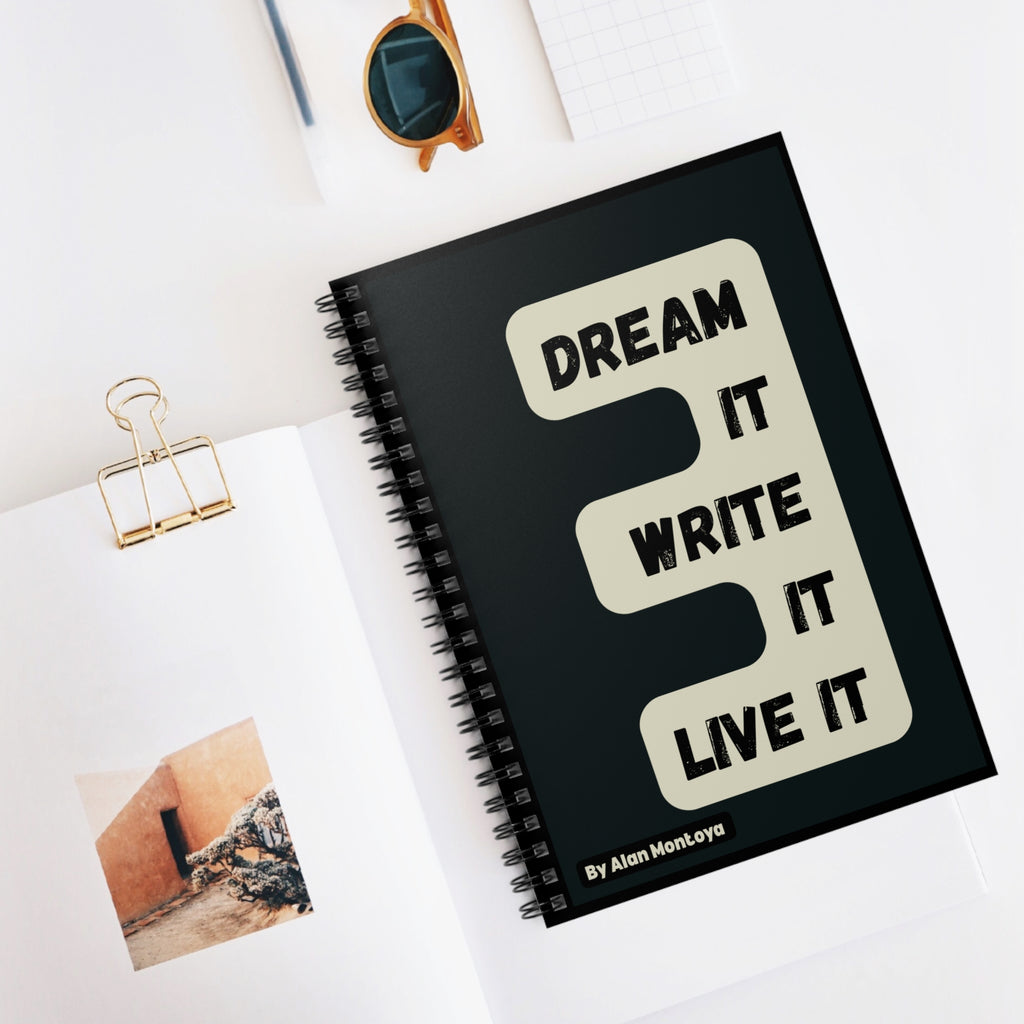 Black notebook with 'Dream It, Write It, Live It' motivation quote 