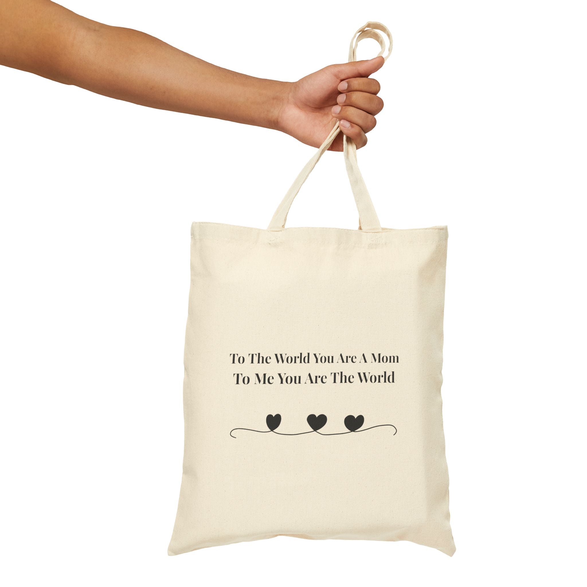 Woman carrying "To The World You Are A Mom" canvas tote bag – meaningful Mother's Day gift